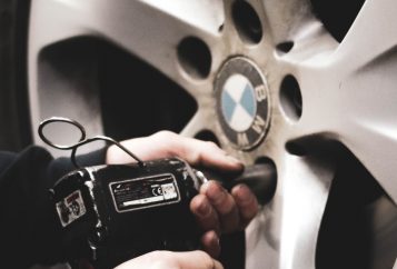 man servicing the wheels of a bmw